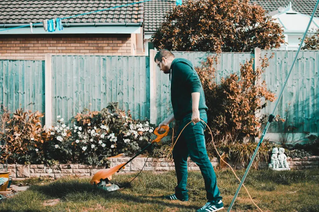Homeowner trimming grass edges in a residential yard in Appleton Wisconsin
